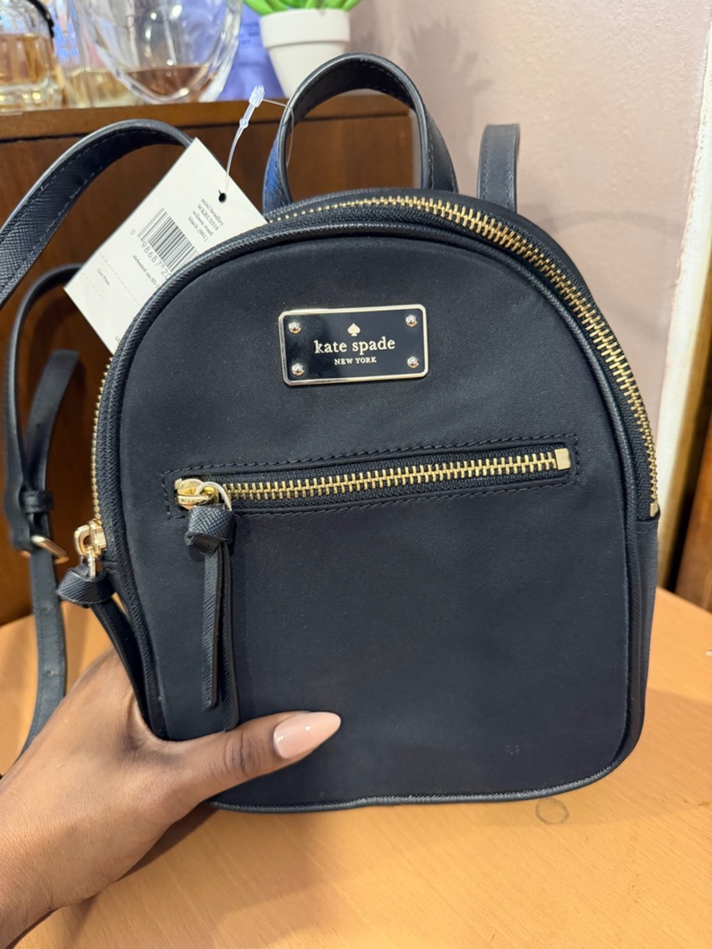 kate spade black mini backpack with gold hardware and front zip
